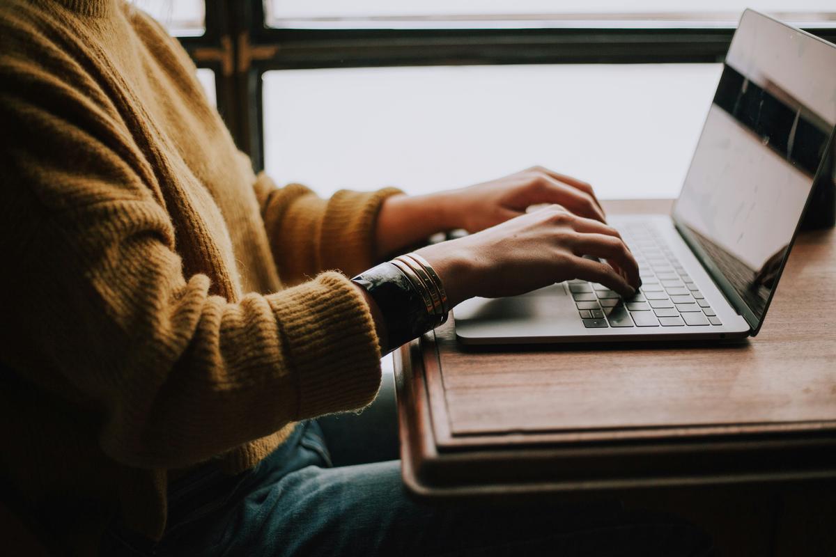 Image of a person working on a laptop with Fiverr logo on the screen